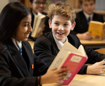 Two students reading a book (Chorlton High School Image) 10